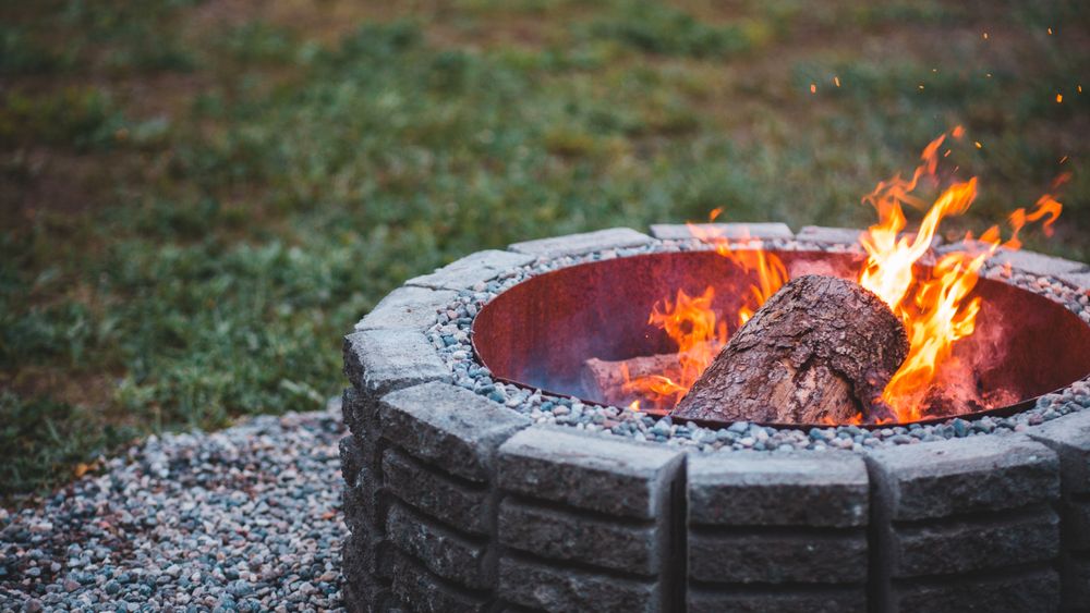 Stone fire pit with a fire lit