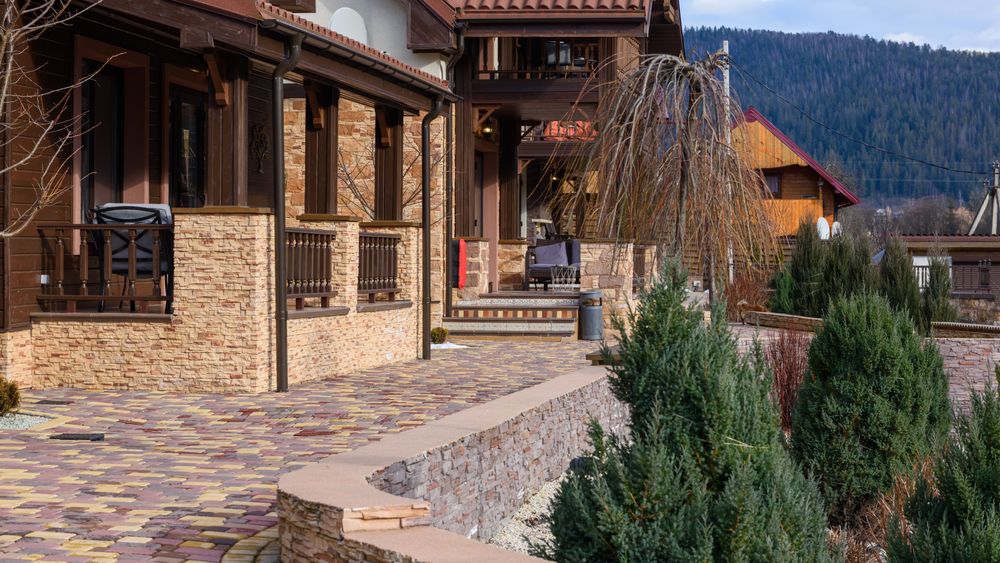 Paver courtyard with a low stone wall