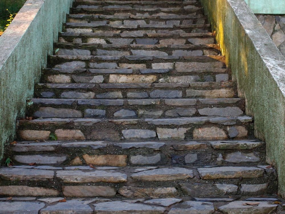Stone steps and a low wall down a grade change